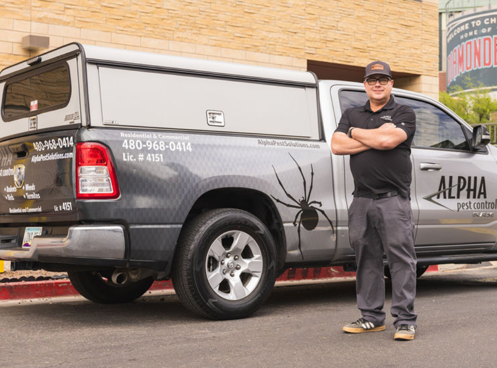 jeff smith owner of alpha pest control in front of alpha pest truck